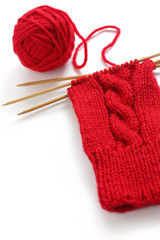 knitting image, a red yarn ball with noodles