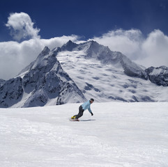 Snowboarder in high mountains
