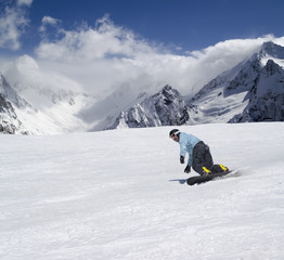 Snowboarder descends a slope
