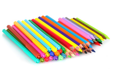 Bright markers and crayons isolated on white