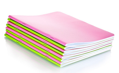 Green and pink notebooks isolated on white