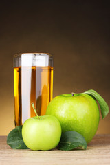 Glass of healthy fresh juice of apples on brown background