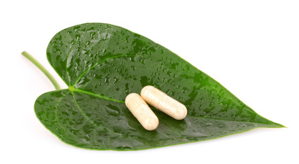 Pills  on leaf isolated on white