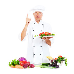 serious chef holding plate with vegetables