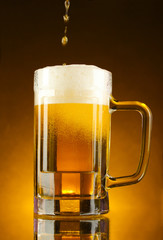 mug of beer on a yellow background