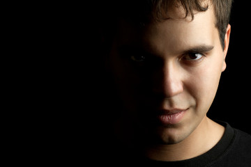 closeup portrait of young man isolated on black background