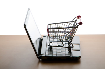 Silhoette of shopping cart and laptop