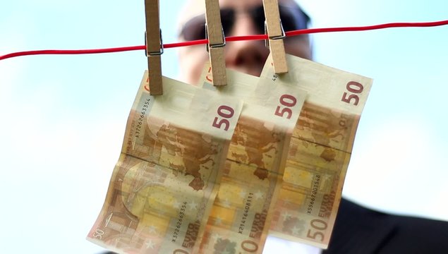 Male - removing money from a clothesline