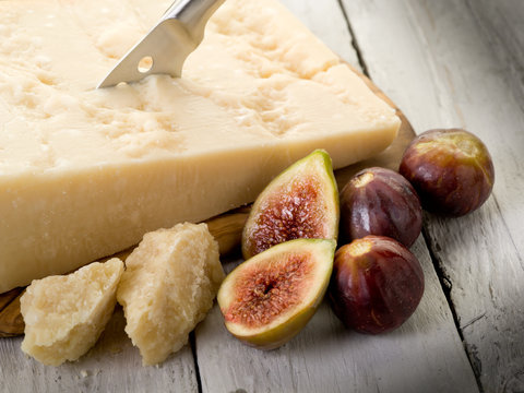 parmesan cheese over cutting board and figs