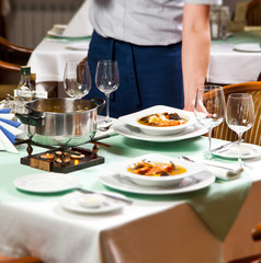 Waiter Serving Food at Restaurant