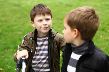 Boy on a bicycle in the green park