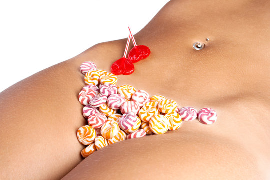 The girl in bikini from sweets, on a white background
