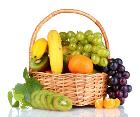 Ripe juicy fruits in  basket isolated on white