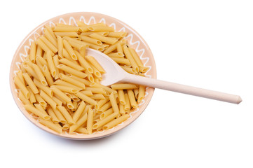Plate with raw pasta and wooden spoon on white background.