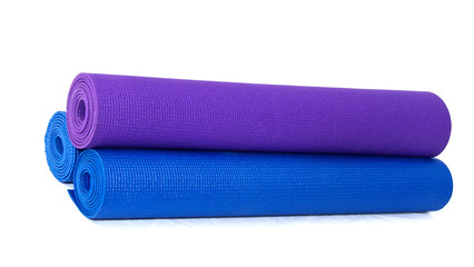 three rolled exercise yoga  mats stacked on white