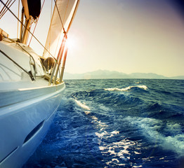 Yacht Sailing against sunset.Sailboat.Sepia toned - obrazy, fototapety, plakaty