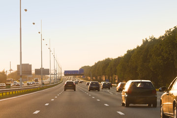 Traffic on highway at sunset