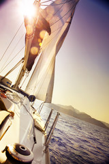 Yacht Sailing against sunset.Sailboat.Sepia toned