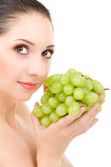 Pretty woman with grape on the white background