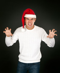 Fototapeta premium man in the bell Santa's face shows terrible