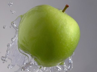 Green apple on a waterfountain