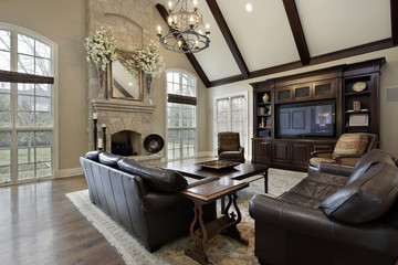 Family room with two story stone fireplace