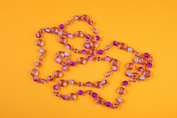 Pink beads on a yellow