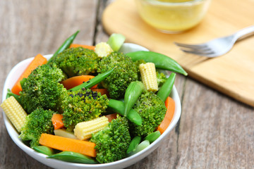 Obraz na płótnie Canvas Broccoli salad with carrot ,baby corn and snap pea