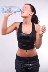 Atractive female drinking water after doing sports.
