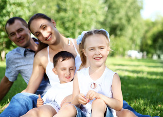 Family with two children in the summer park