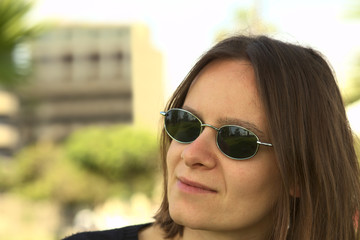Fototapeta na wymiar Portrait of a young woman in sunglasses