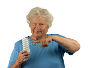 senior woman is pointing to a energy efficient light