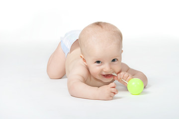 Happy baby with a toy on the white background