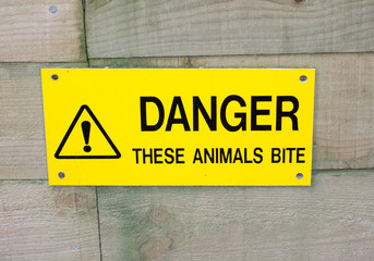 dangerous animals sign on wooden background