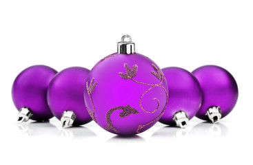 Purple christmas baubles on white