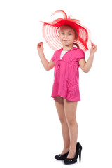 Beautiful little lady in a high heel shoes and hat
