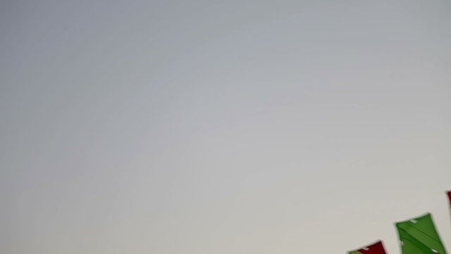 a line of kites attached together flying in the air