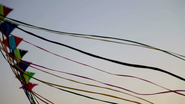 a line of kites attached together flying in the air
