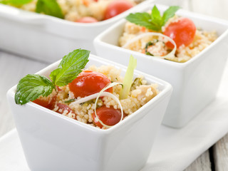 vegetable couscous with cerry tomatoes and mint leaf