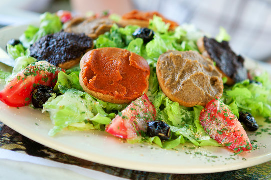Delicious Provencal salad: fresh vegetables, olives, olive oil a