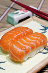 Yummy salmon. A close-up of chopsticks and a square plate with t