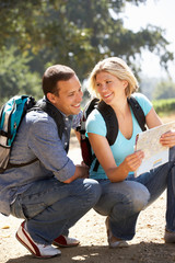 Fototapeta premium Couple with map on country walk