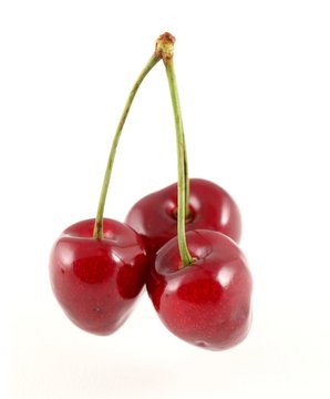 Three cherries against a white background