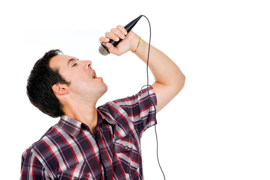 Image of a handsome young man singing to the microphone, isolate