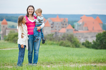 Fototapeta premium Travelers. Young mother with her two children