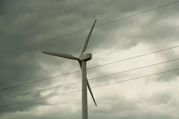 Cercles muraux Moulins Wind turbine against clouds