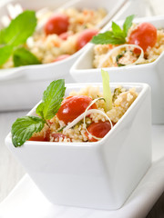 vegetable couscous with cherry tomatoes and mint leaf