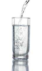 Pouring water on glass isolated on white