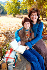 mother and daughter reading in garden