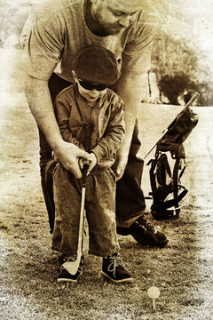 father and son play golf